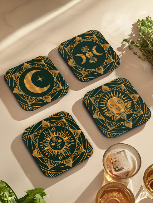 A set of four square coasters with a glossy finish, featuring celestial gold designs on a deep forest green background. Each coaster showcases a unique motif: a stylized sun with a serene face, a crescent moon with a star, a triple moon symbol with botanical elements, and a radiant sunburst. The intricate gold linework creates an art deco-inspired, mystical aesthetic. Made from durable materials, these coasters blend elegance with celestial charm.